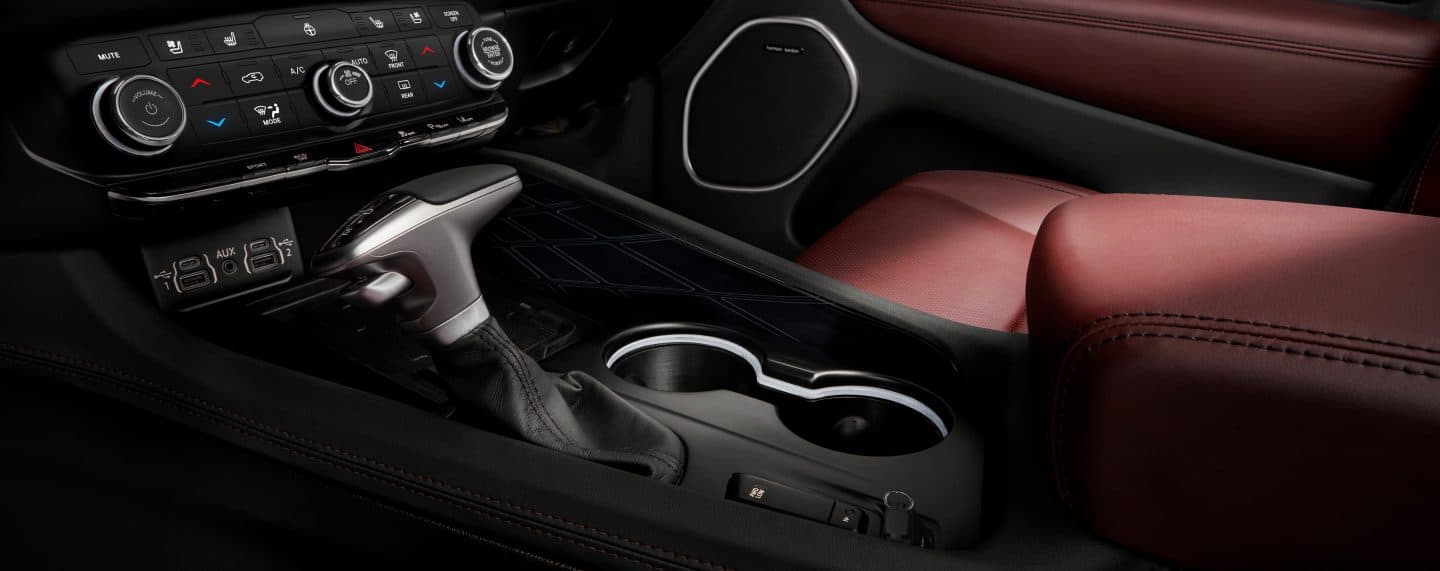 A close-up of the shifter and cup holders in the center console of the 2023 Dodge Durango.