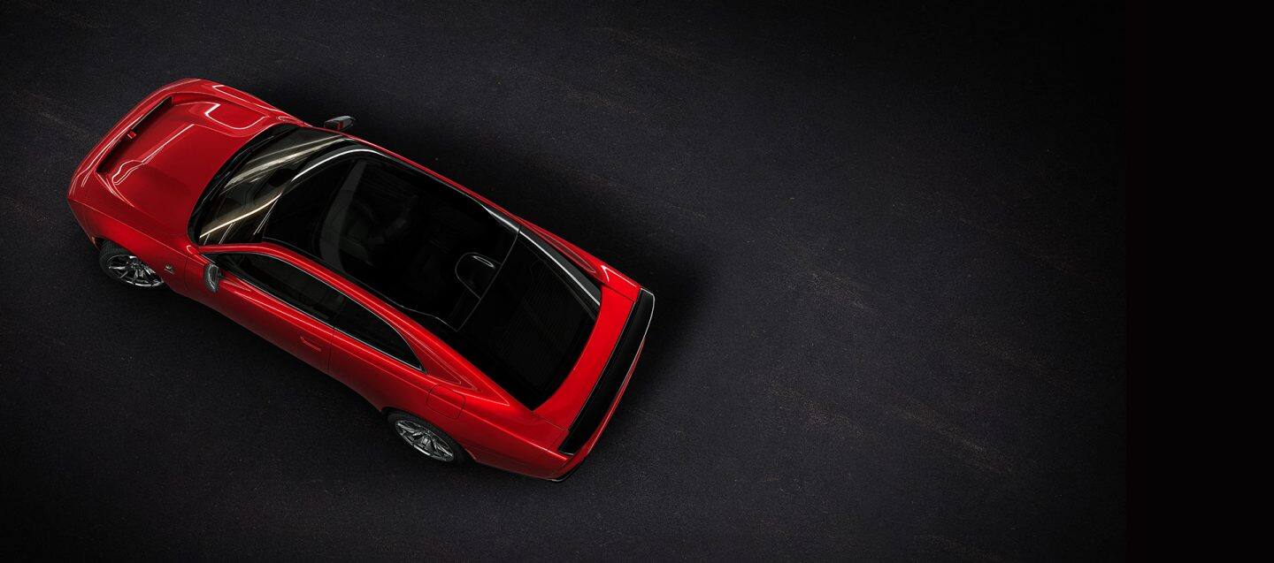 An overhead angle of a red 2024 Dodge Next-Gen Charger Scat Pack highlighting its panoramic glass sunroof.