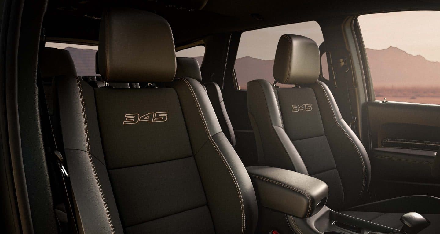 Display The front seats in a 2025 Dodge Durango R/T 20th Anniversary Edition with 345 embroidered on them.