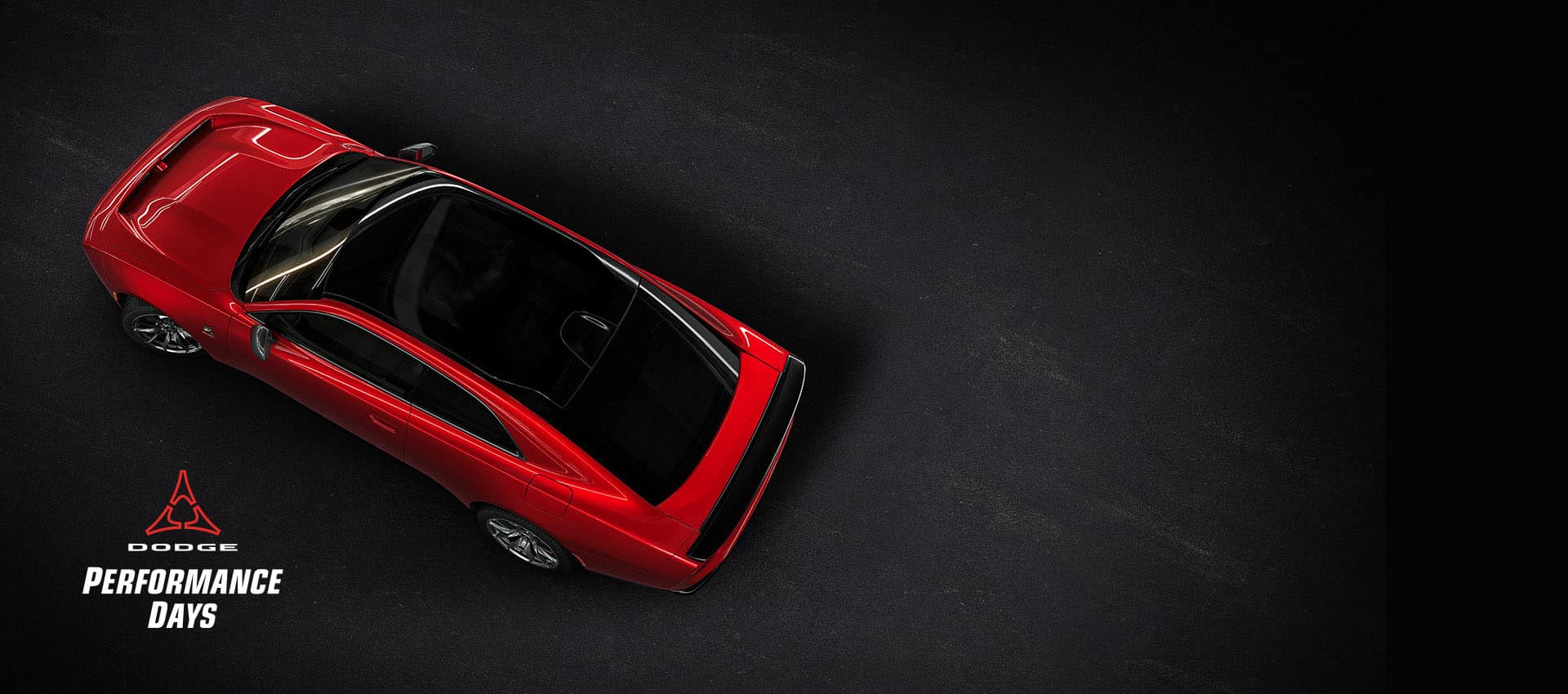 An overhead angle of a red 2024 Dodge Next-Gen Charger Scat Pack highlighting its panoramic glass sunroof. Performance Days Sales Event.